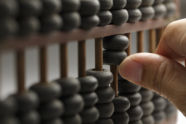 Old wooden abacus with a calculated