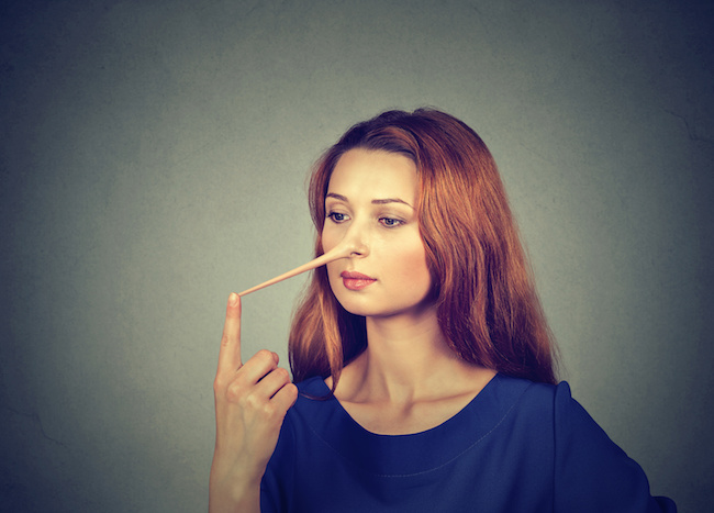 Woman with long nose isolated on grey wall background. Liar concept. Human face expressions, emotions, feelings.